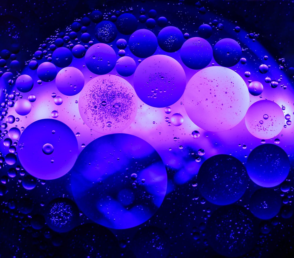 a blue and purple background with bubbles of water