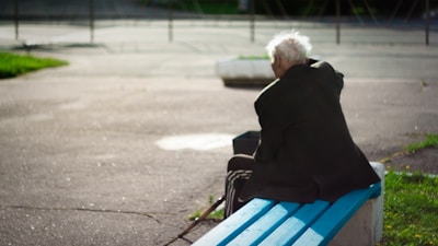 person sitting on wooden bench