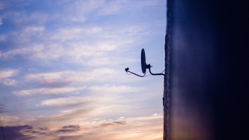 a weather vane on the side of a building