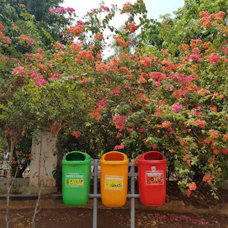 Brightly colored plastic garden pots and trash bins arranged outdoors.