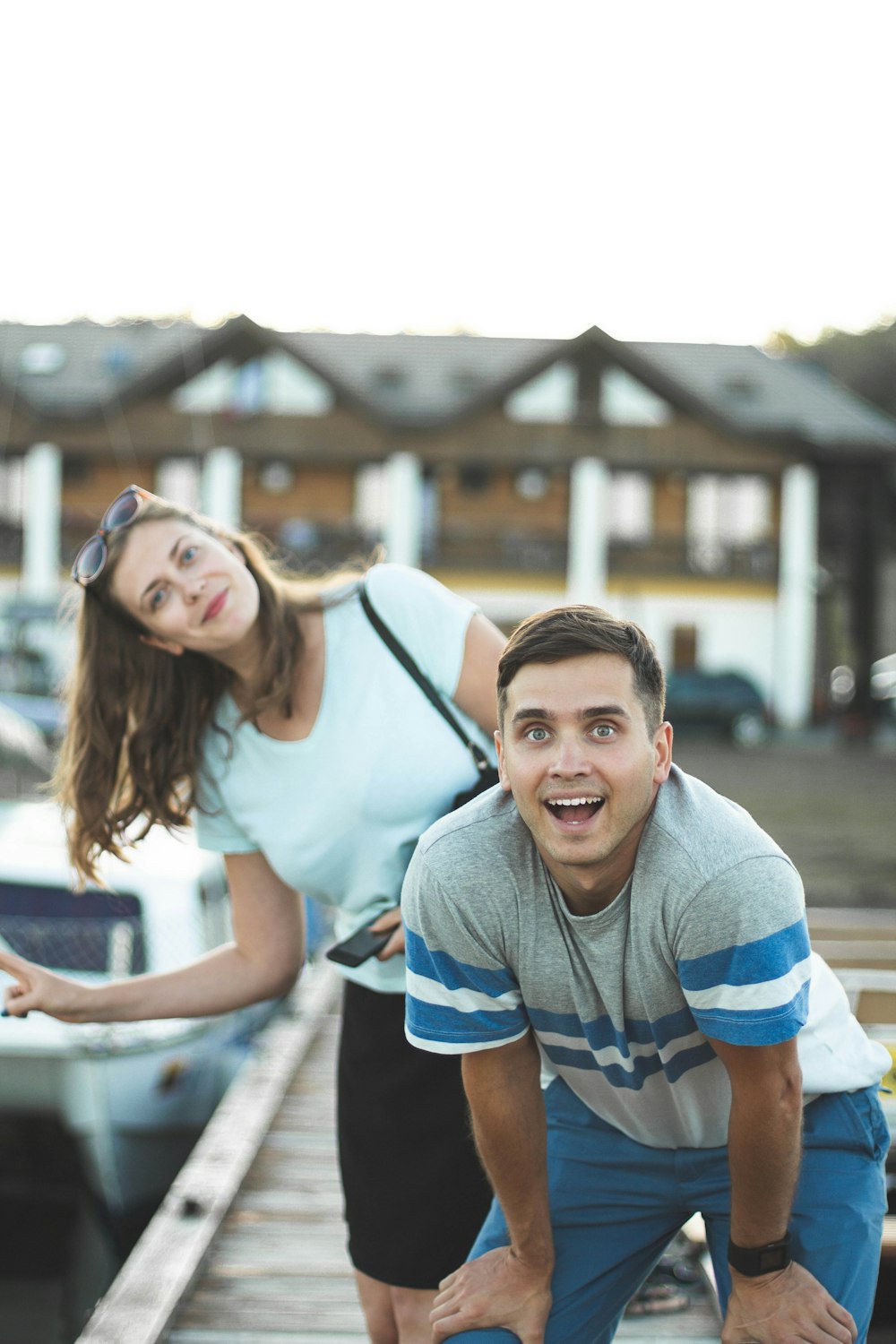 man and woman standing on wooden dock