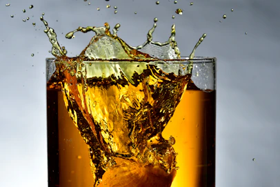 clear drinking glass filled with brown liquid