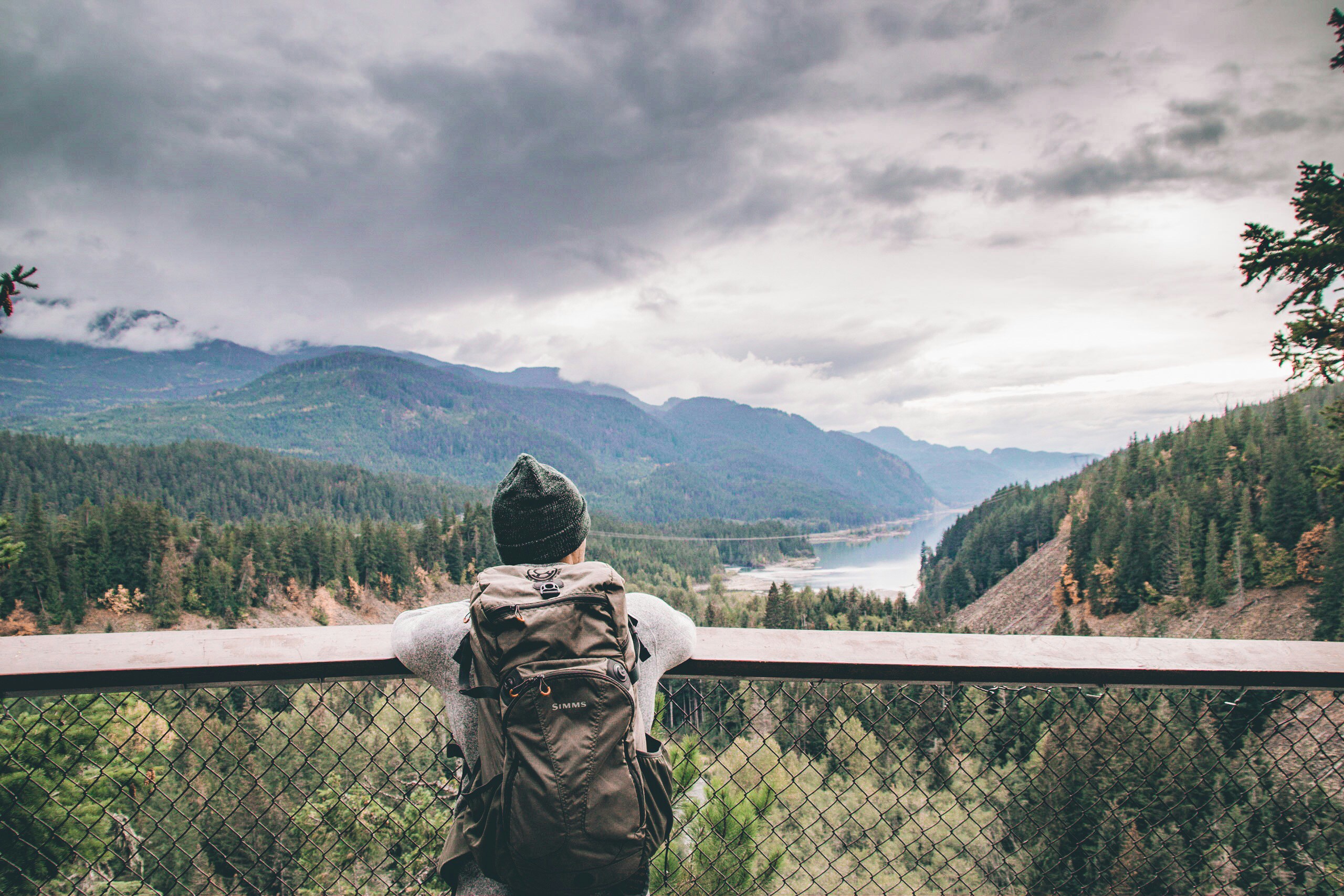 person standing beside rail