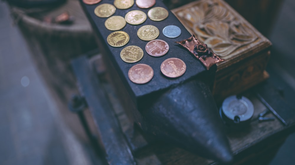 coins on black anvil