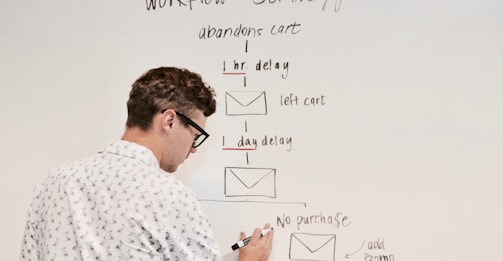man writing on white board