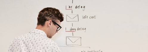 man writing on white board