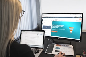 woman sitting in front of turned-on computer monitor