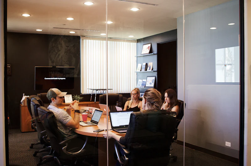 Team comparing software workflow options around a table