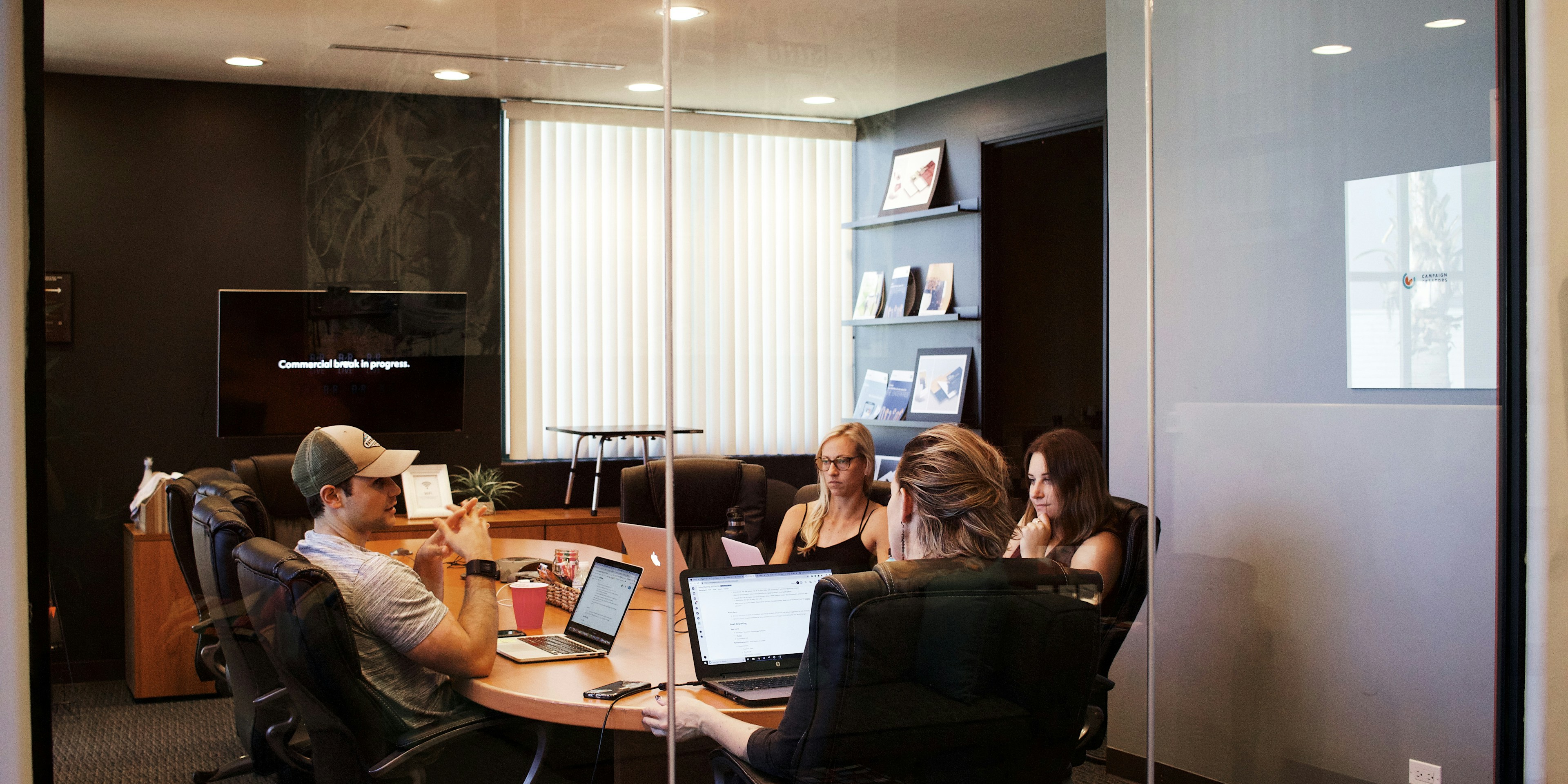 people sitting near a table with a laptop