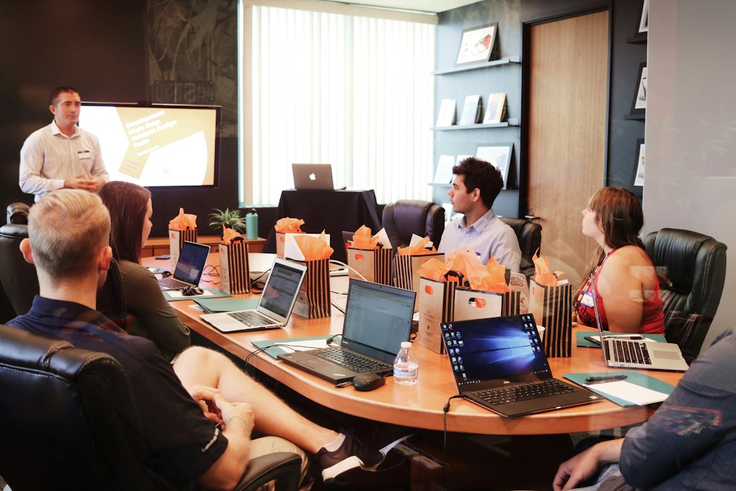 Conference room session with open laptops — enterprise website design