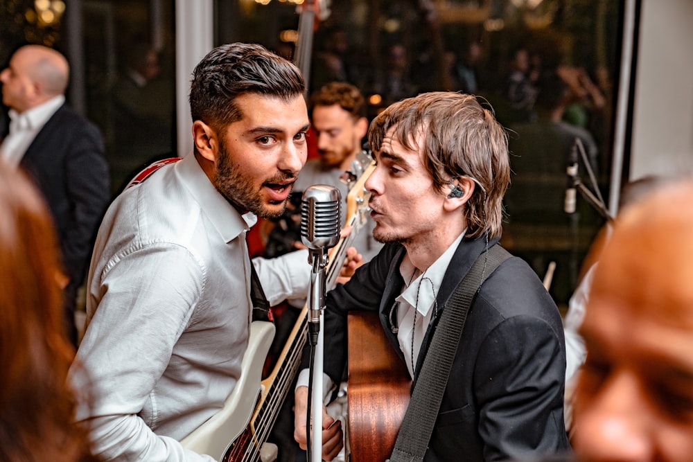 men playing guitar and singing