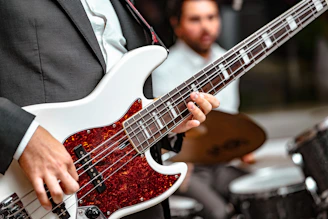 man playing 5-string bass guitar