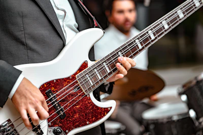 man playing 5-string bass guitar