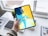 A professional designer reviewing vibrant creative visuals on a digital tablet in a modern office.