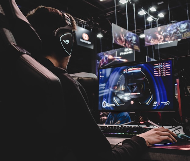 person sitting on gaming chair while playing video game