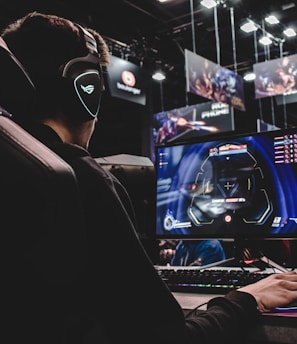 person sitting on gaming chair while playing video game