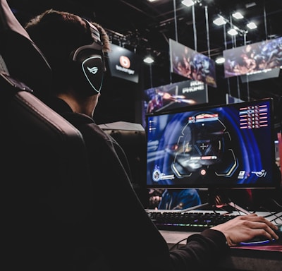 person sitting on gaming chair while playing video game