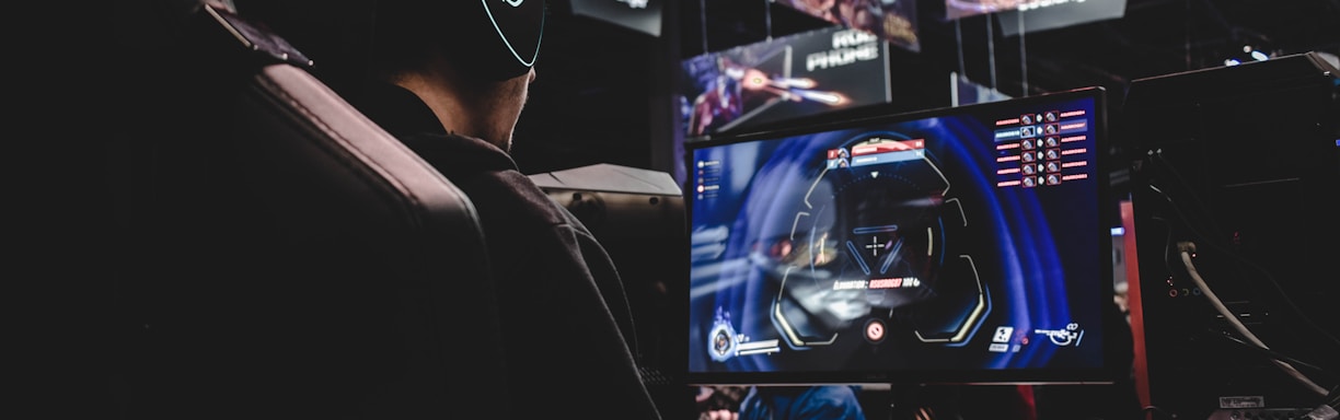 person sitting on gaming chair while playing video game