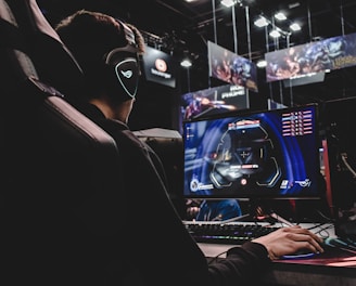 person sitting on gaming chair while playing video game