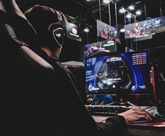 person sitting on gaming chair while playing video game