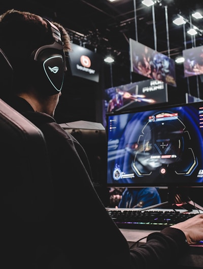 person sitting on gaming chair while playing video game