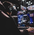 person sitting on gaming chair while playing video game