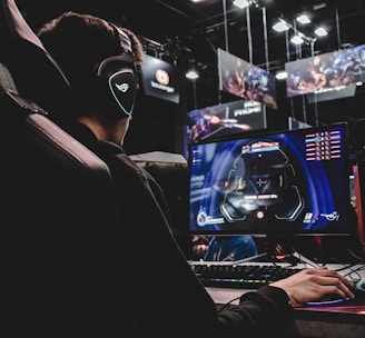 person sitting on gaming chair while playing video game