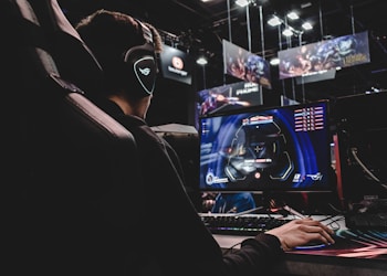 person sitting on gaming chair while playing video game