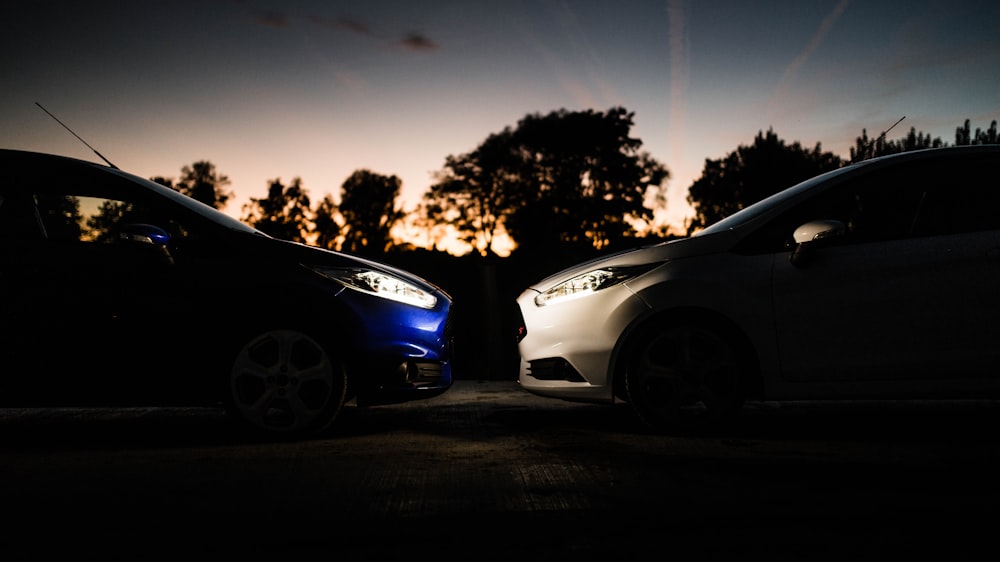 silver and blue vehicles facing on concrete road