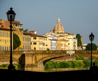 Iconic European landmarks including Amsterdam canals and Prague’s Charles Bridge under a bright sky.