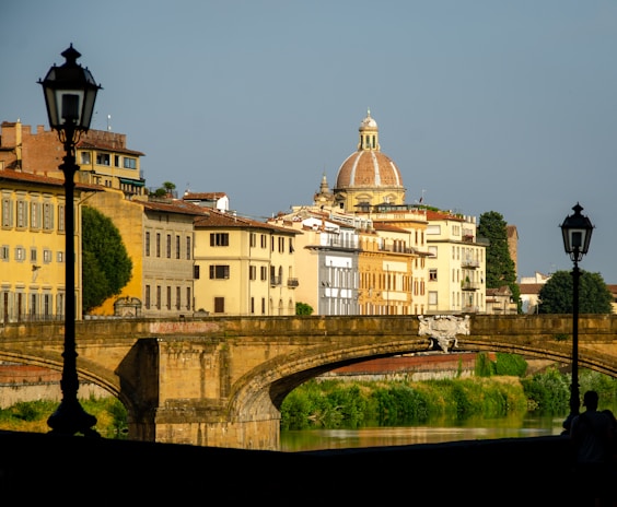 Iconic European landmarks including Amsterdam canals and Prague’s Charles Bridge under a bright sky.