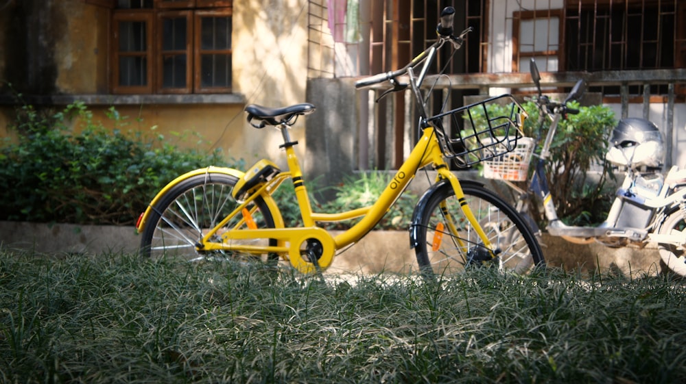 yellow city bicycle on grass during daytime