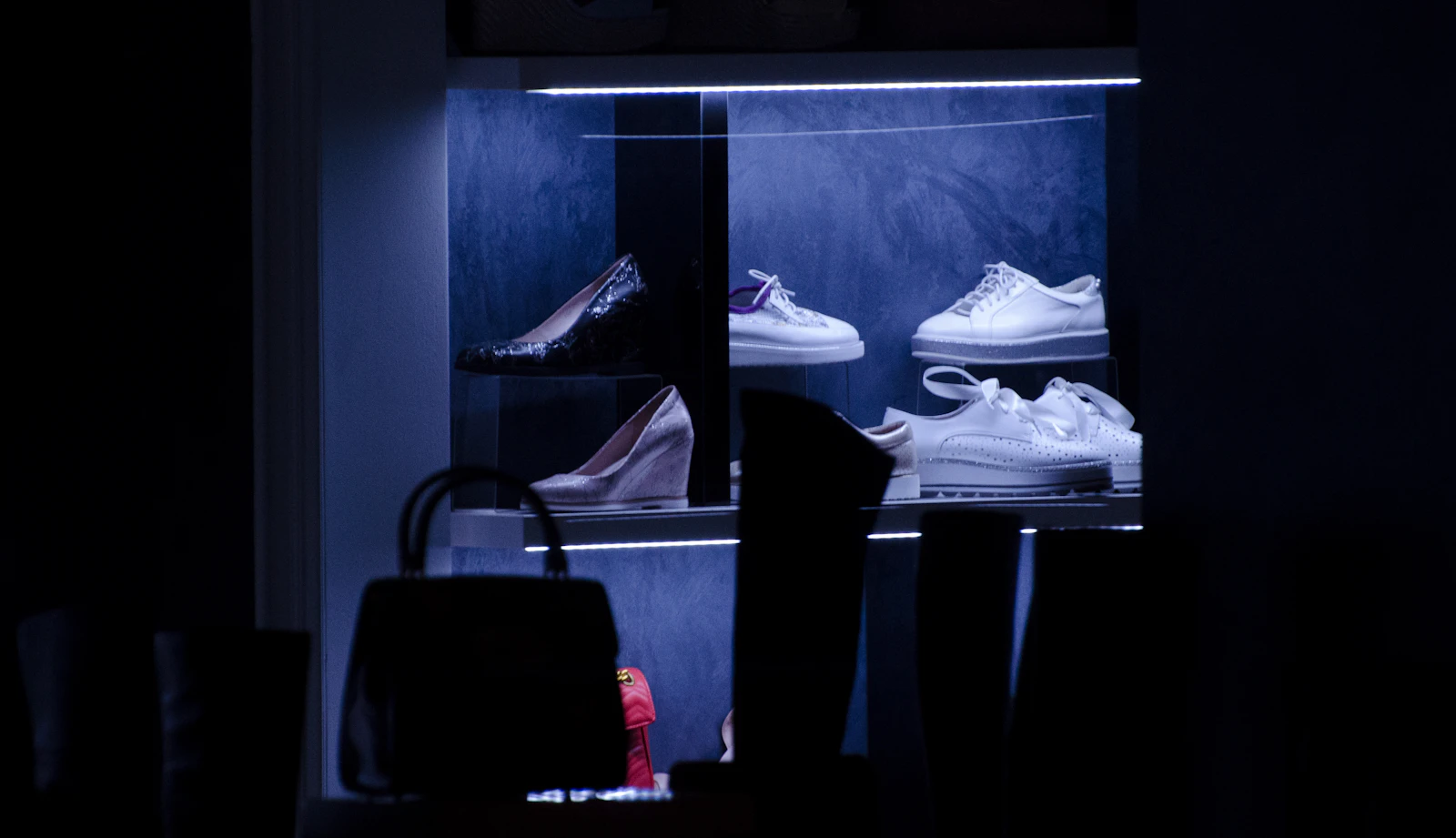 Lit sneaker display in dark room