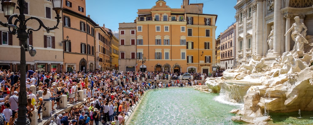 crowd of people gathered in front of Trevi Fountain