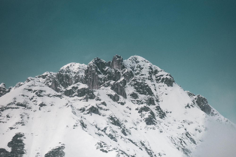 snowy mountain under calm blue sky