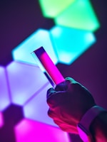 Close-up of hands holding a smartphone showing a digital download screen with pastel pink accents