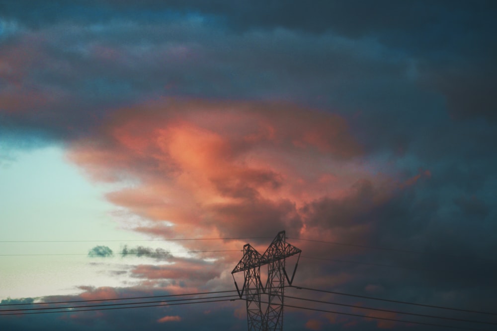 the sky is filled with clouds and power lines