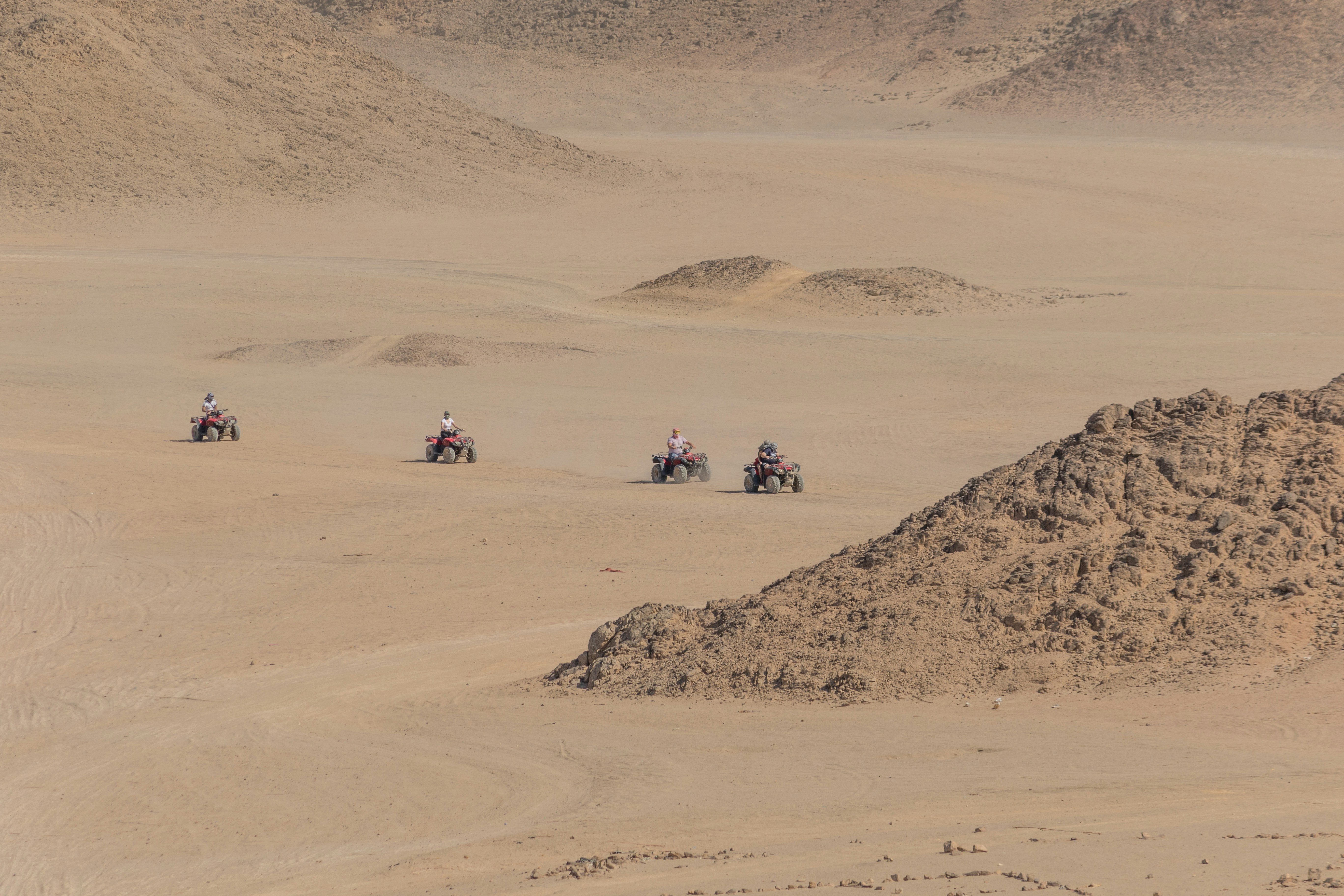 four person riding on ATV, I went on a desert quad biking adventure in Egypt. This is the second photo I took of the quad bikes in the desert, it would have been perfect to get an evenly spaced line in the desert.