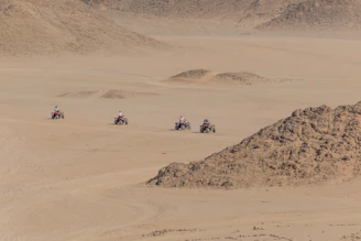 A group of friends enjoying an ATV ride through rugged Texas trails under a bright blue sky.