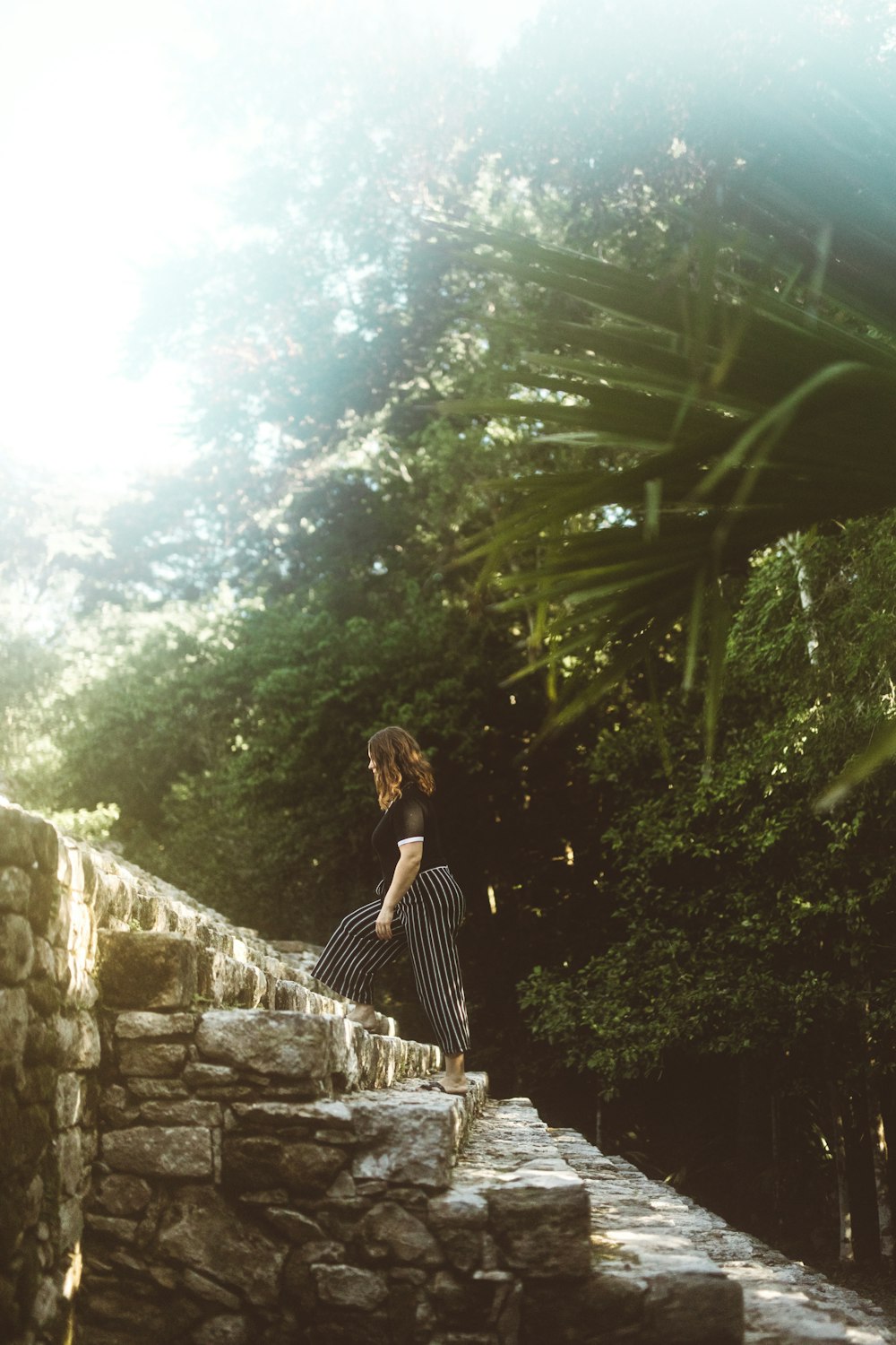 woman walking on stair during daytime