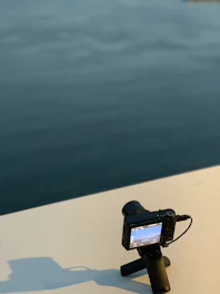 Close-up of a film camera lens reflecting a serene meditation scene.