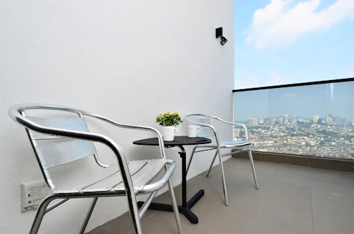 Industrial steel dining set on a modern urban balcony.