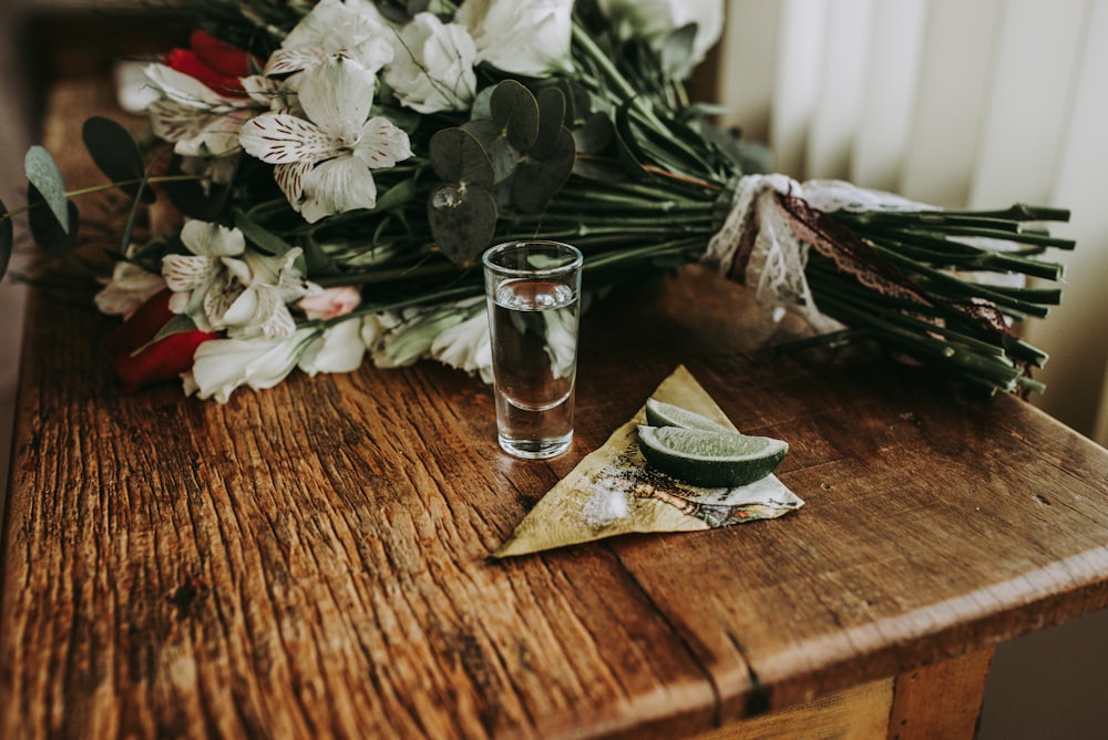 clear drinking glass on top of brown table