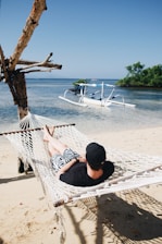 person lying on hammock during daytime