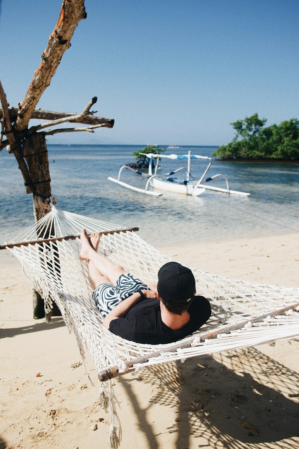 person lying on hammock during daytime