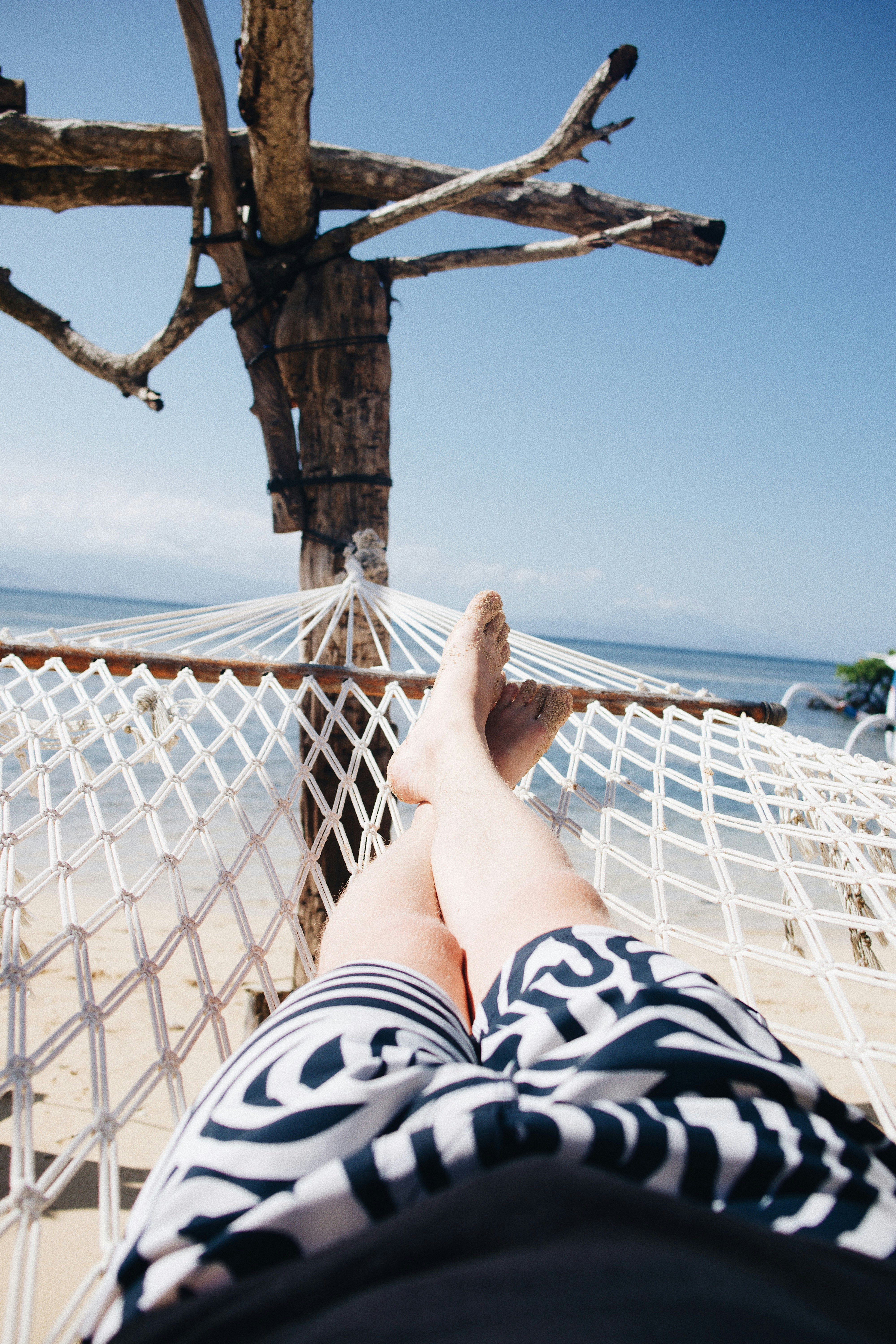 person on hammock near sea