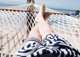 person on hammock near sea