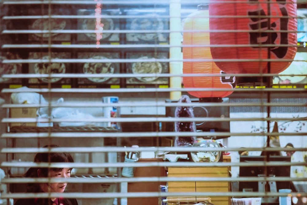 a woman sitting at a desk in front of a window