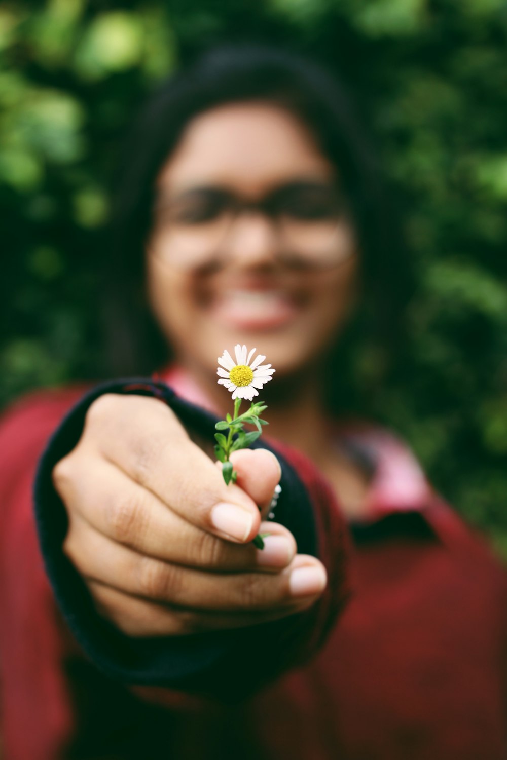 woman standing and holding white petaled flowers