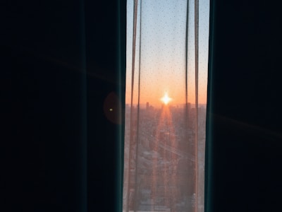 A sunrise view from a window, symbolizing new beginnings and personal growth.